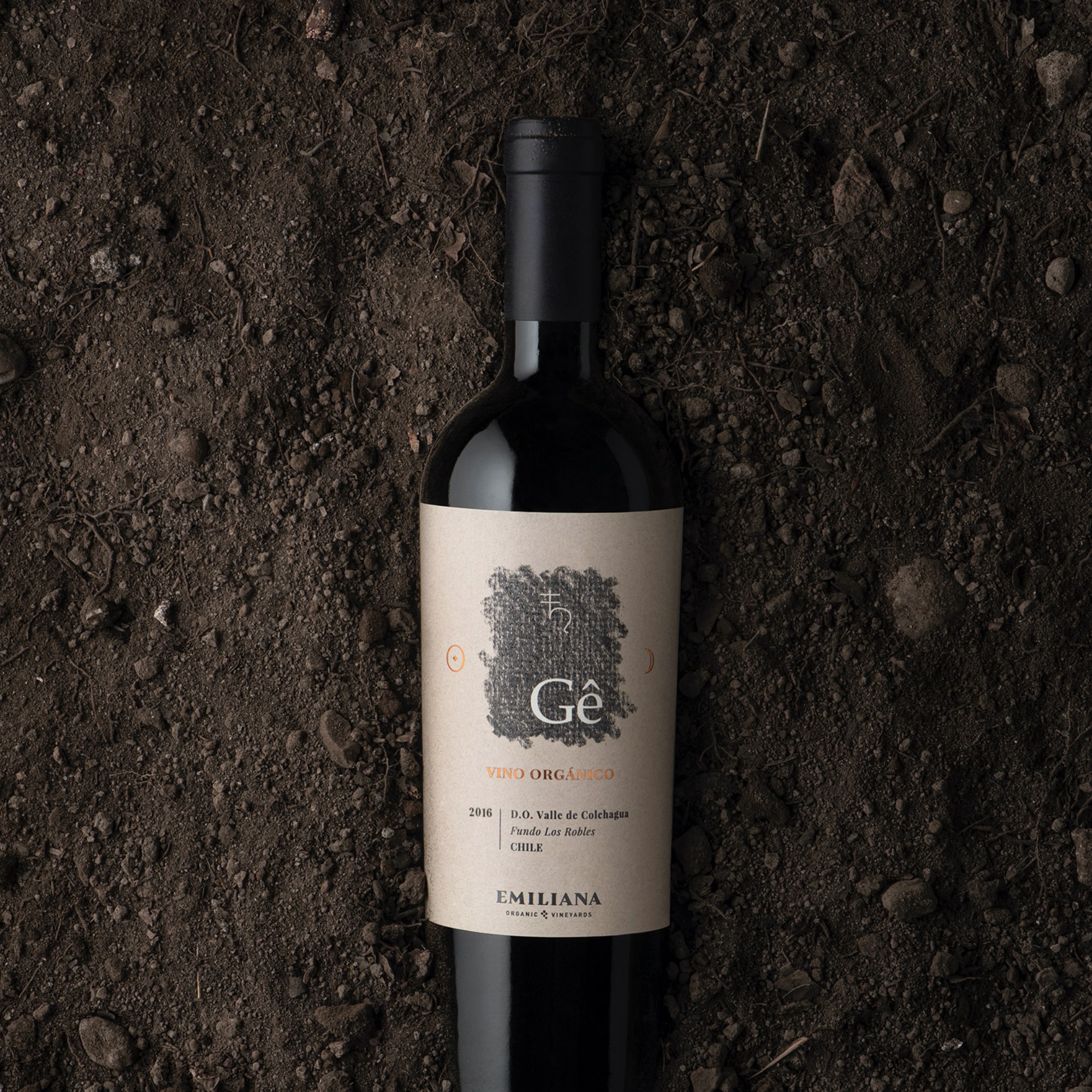 Emiliana Gé Organic Red Wine bottle with vineyard background